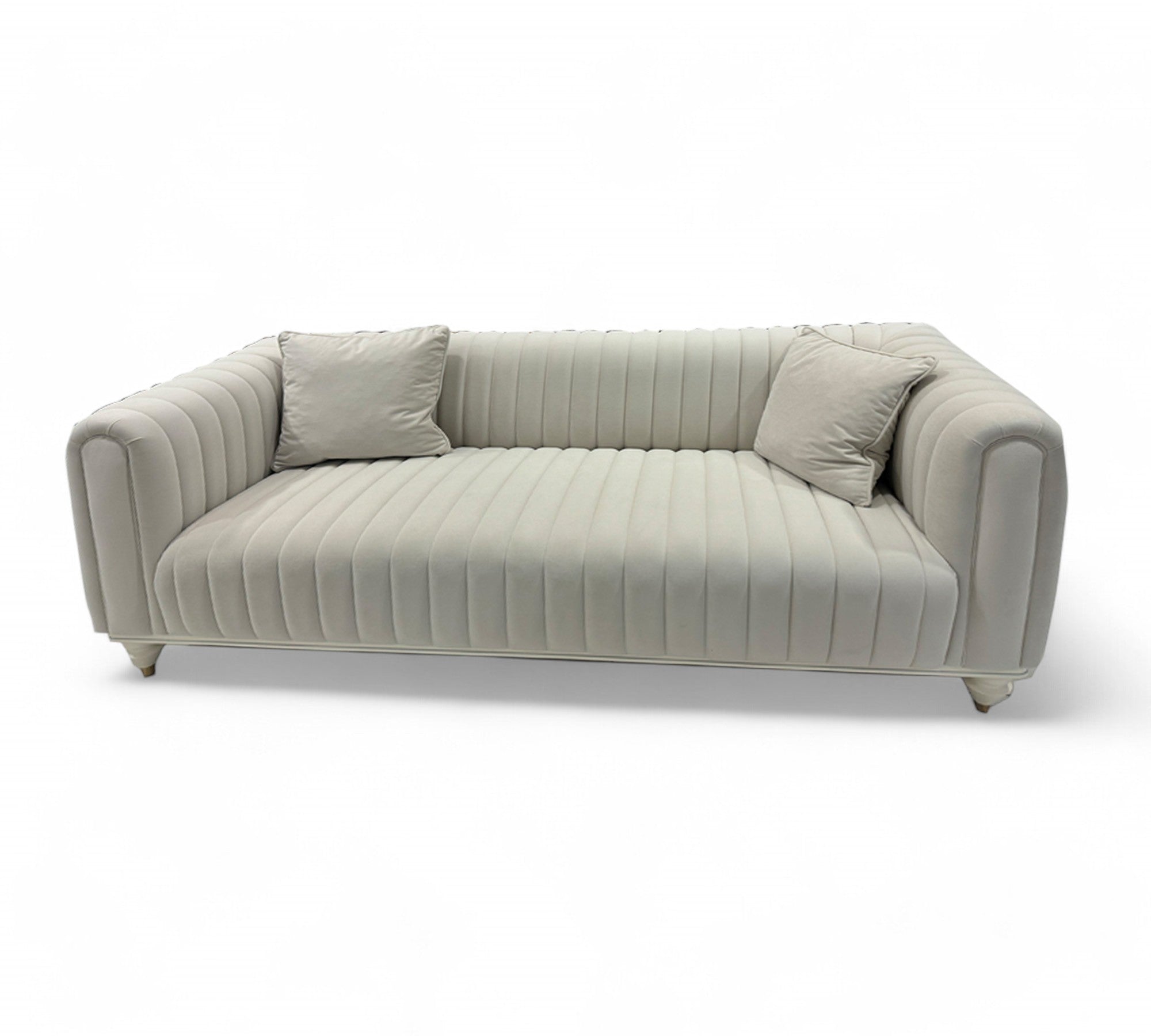 A beige Inci Loveseat sofa with a velvet upholstery, sleek design, and wooden legs placed against a white background.