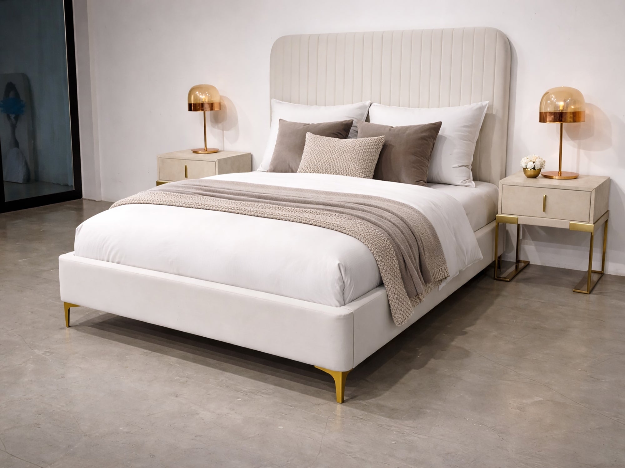 Neatly made bed with pillows and a blanket in a bedroom setting.