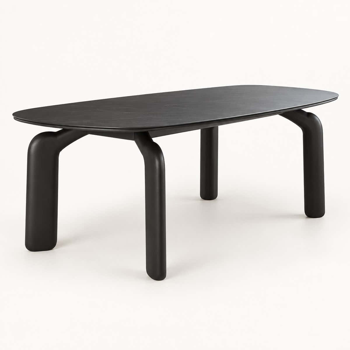 Avero black ceramic dining table with sculptural carbon steel legs on a neutral studio background
