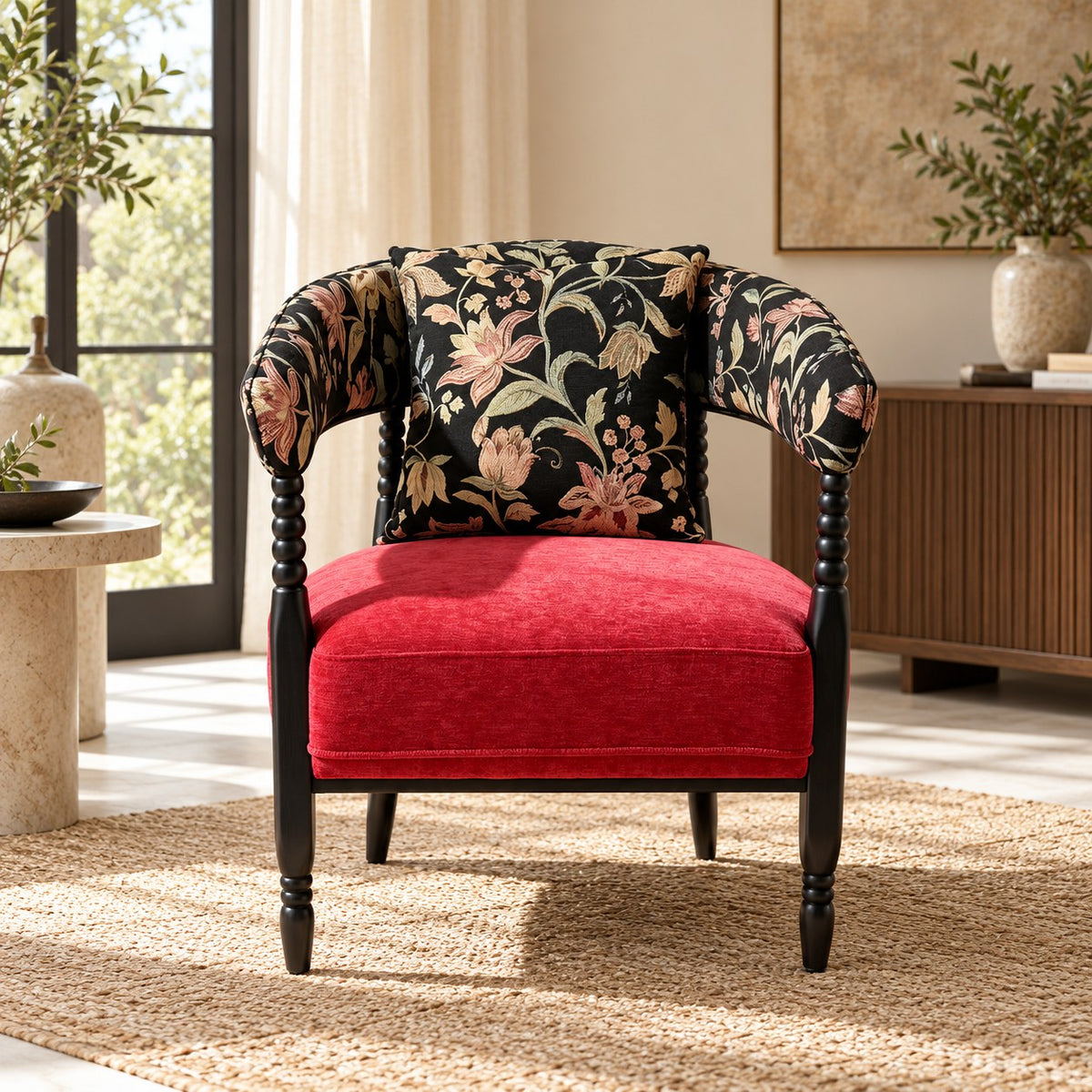 Red and black floral accent chair with dark sculptural frame styled in a room.