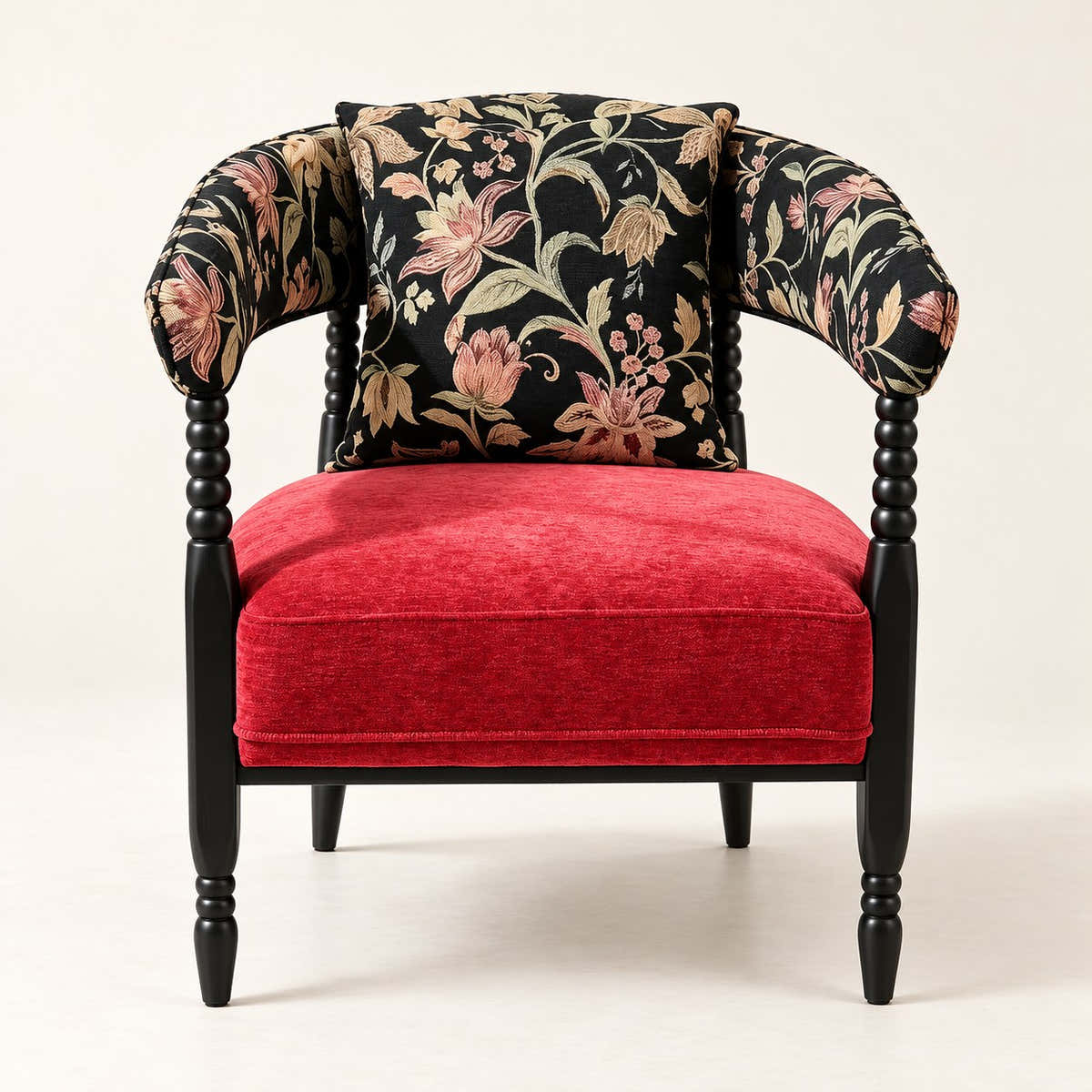 Red and black floral accent chair with dark sculptural frame on a neutral background.