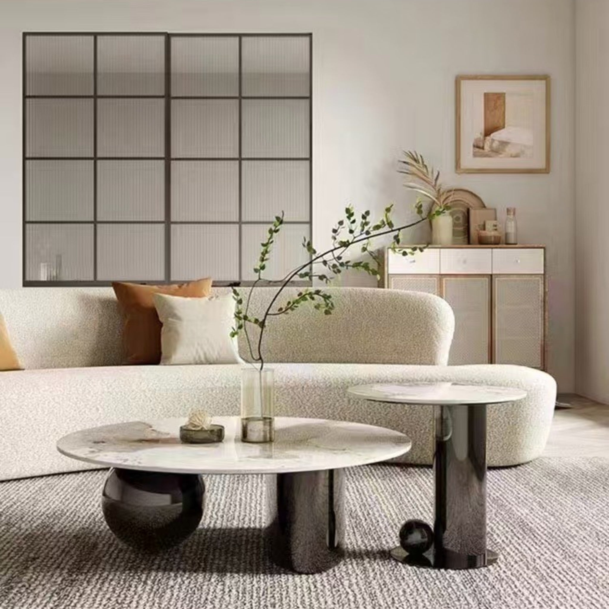 Modern living room with a white sofa, marble coffee table, and decorative elements.