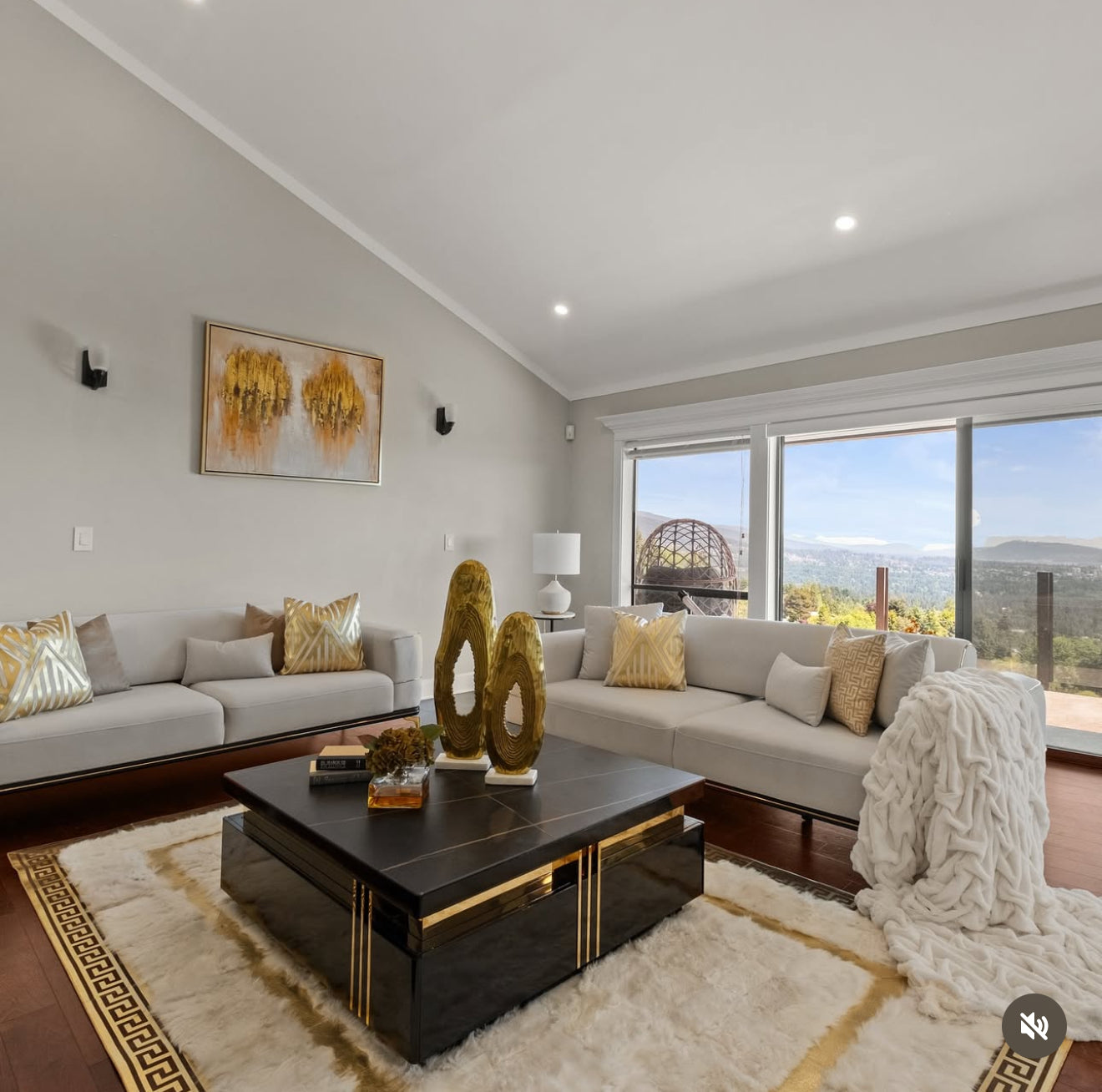 Modern living room with gray sofa, coffee table, and decorative elements.