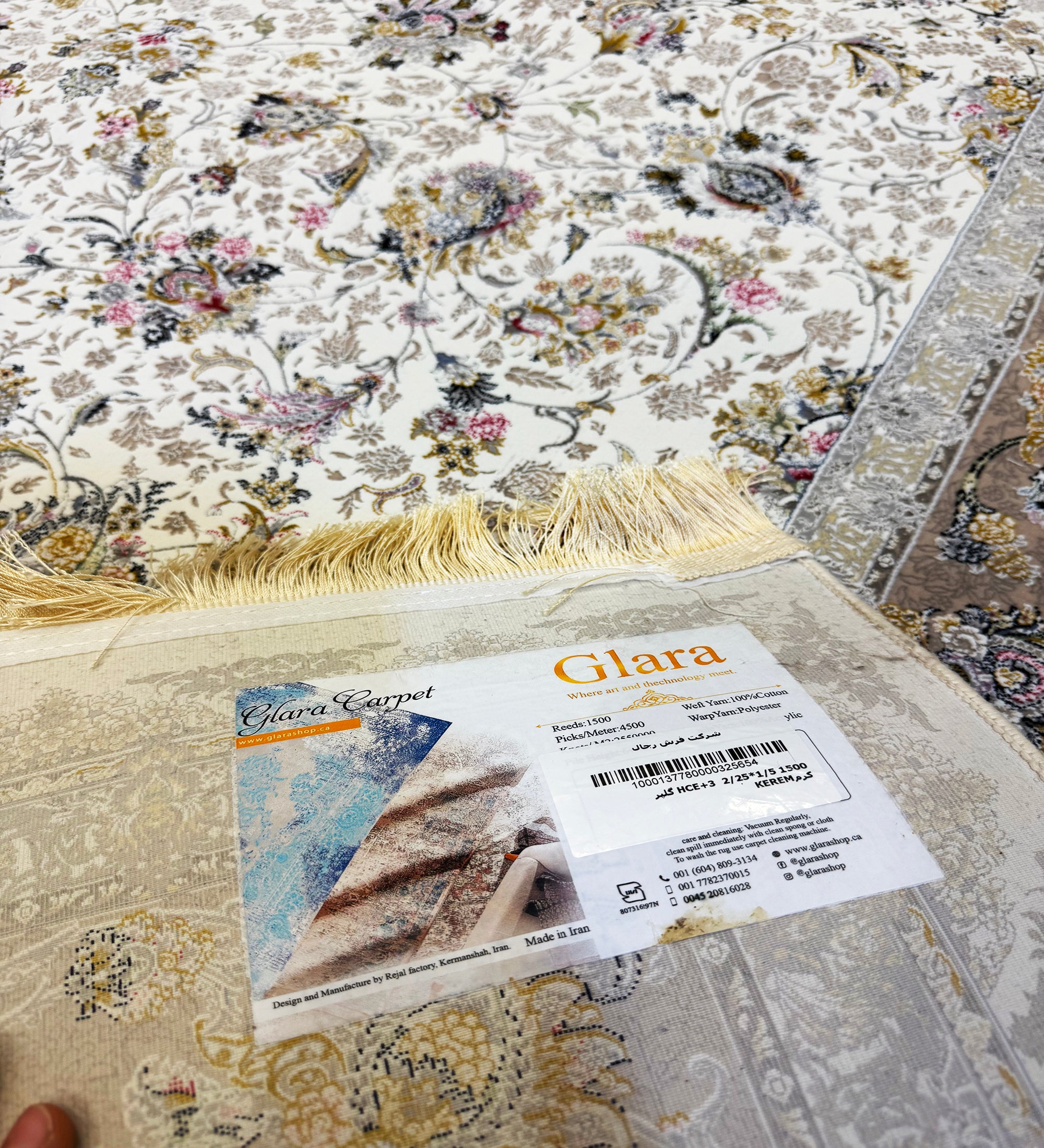 Floral-patterned rug with a Glara label on top