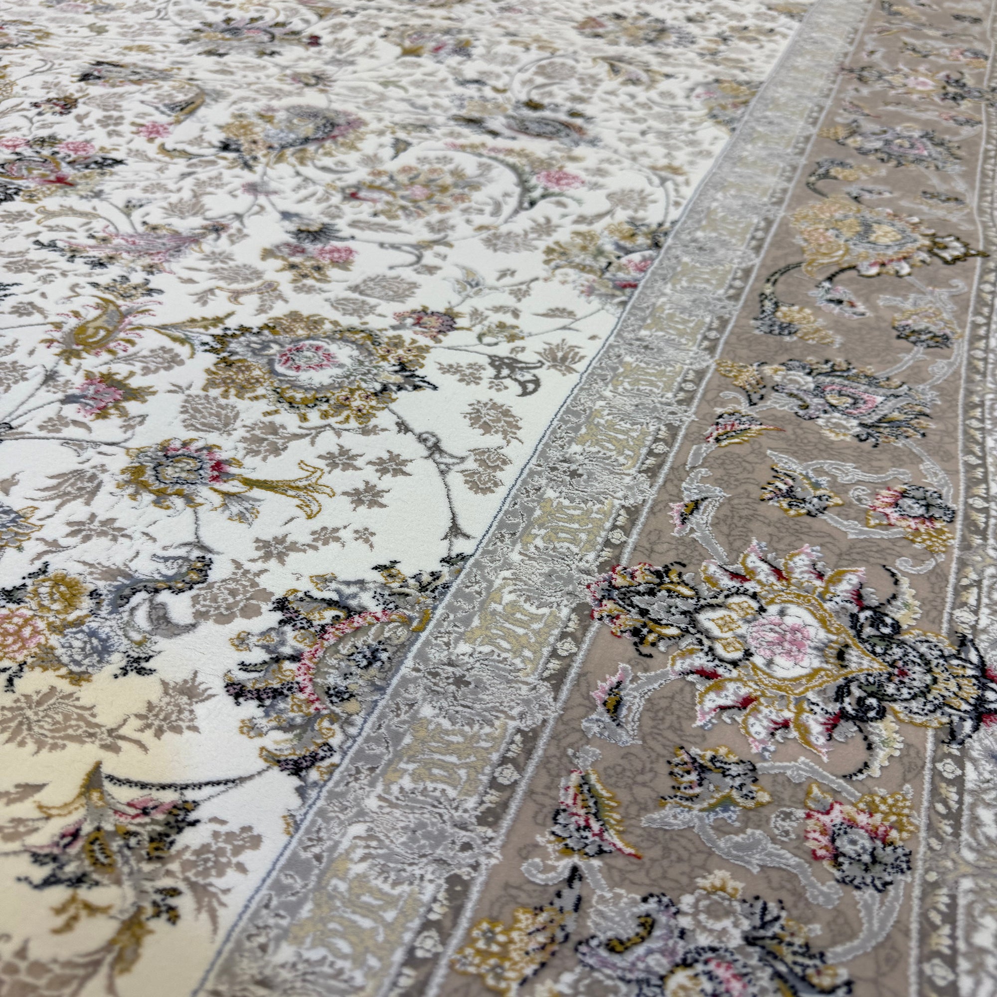 Close-up of two patterned rugs with floral designs on a neutral background.