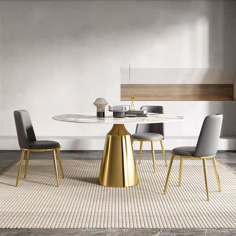 Dining room with a round table and chairs in a modern interior setting.