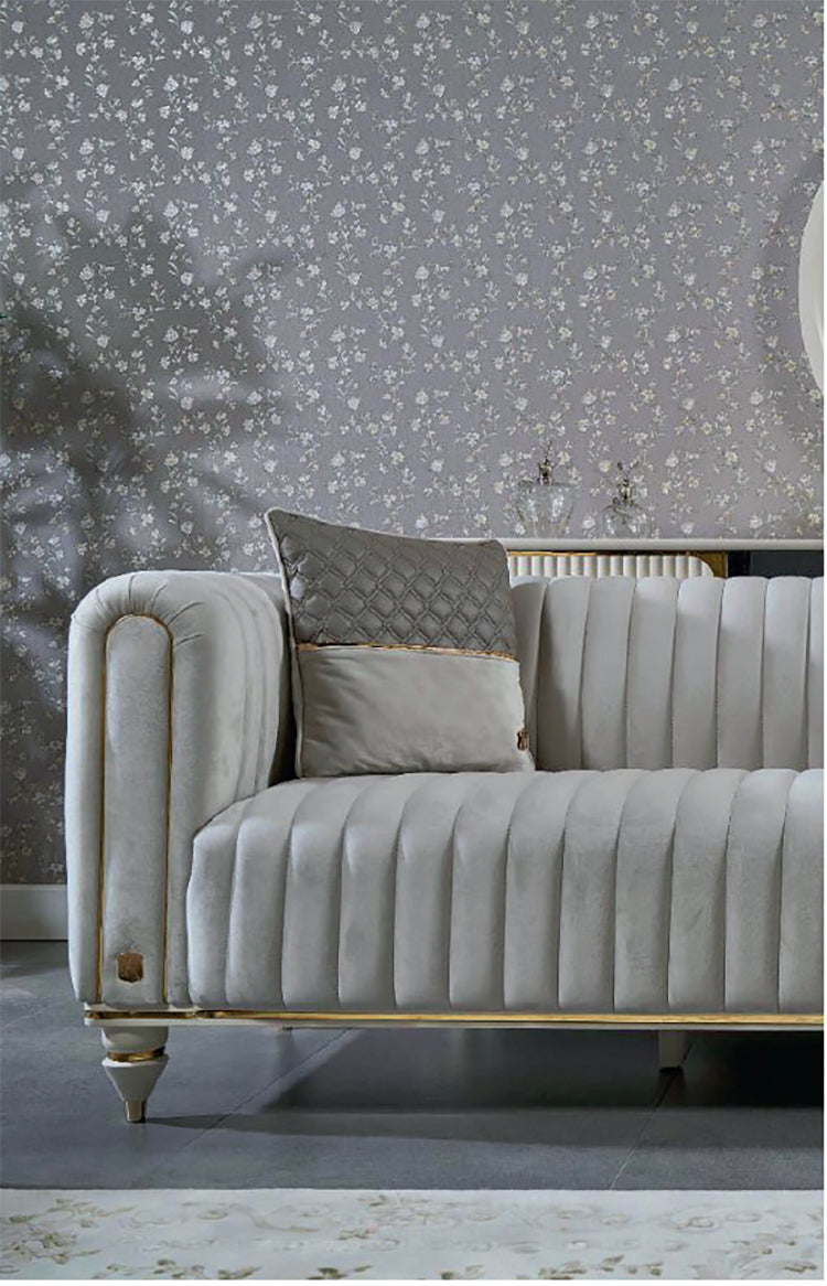 Gray sofa with decorative pillows against a patterned wall.