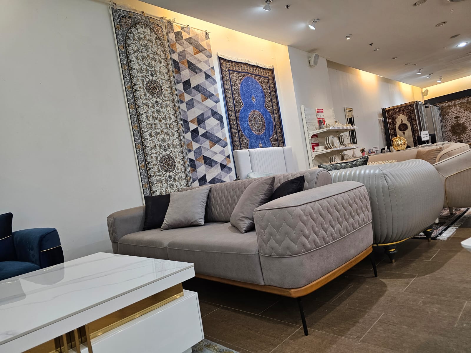 Modern living room with gray sofa, coffee table, and decorative wall art.