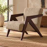 Beige textured accent chair with angular dark wood arms styled in a room.