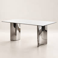 White ceramic dining table with two reflective chrome-tone pedestals on a neutral background.