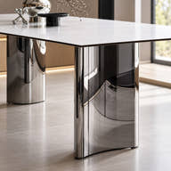 Curved reflective stainless steel pedestal.