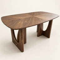 Wood-veneer dining table with rounded top and open-cutout supports on a neutral background.