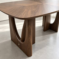 Sculptural support with curved open cutout.