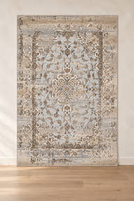 Afsana FF-10 grey and beige floral rug shown upright in a digitally edited clean showroom