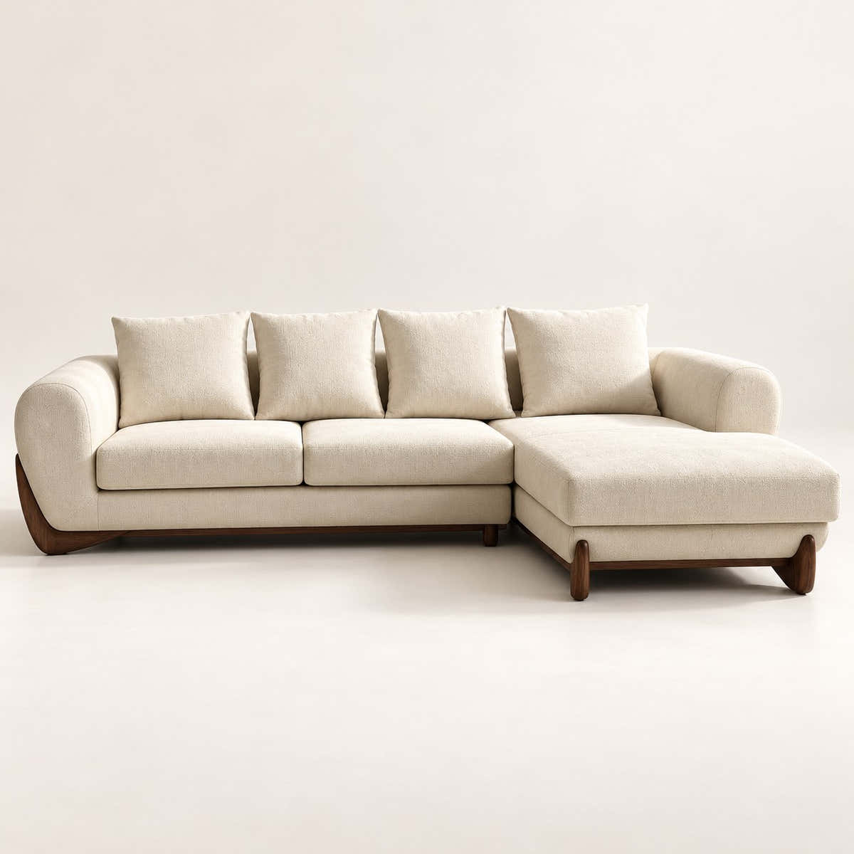 A modern sectional sofa with a right-facing chaise lounge, upholstered in a warm cream fabric with dark brown wooden legs, shown against a plain off-white background.