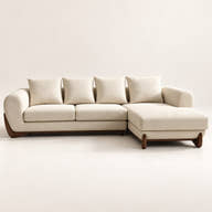 A modern sectional sofa with a right-facing chaise lounge, upholstered in a warm cream fabric with dark brown wooden legs, shown against a plain off-white background.