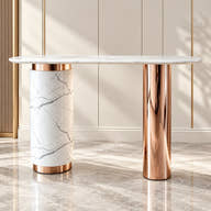 White veined marble console with asymmetrical rose-gold pedestal base styled in a room.