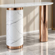 Asymmetrical cylindrical pedestals and rose-gold bands.